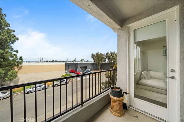 a view of a balcony with chair and tables