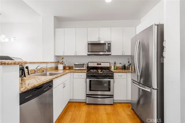 a kitchen with a sink appliances and cabinets