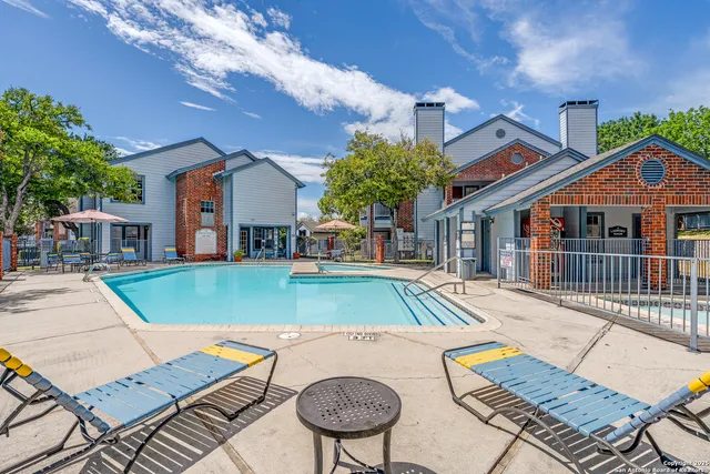 a view of a patio with swimming pool table and chairs