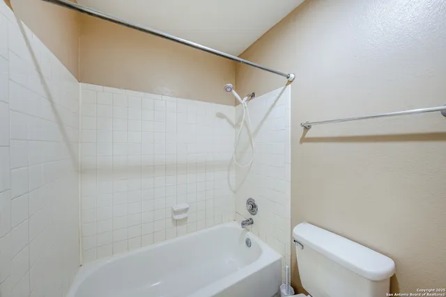 a bathroom with a toilet and a bathtub