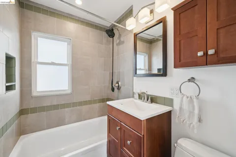 a bathroom with a sink mirror vanity and toilet