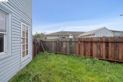 a view of a backyard with wooden fence