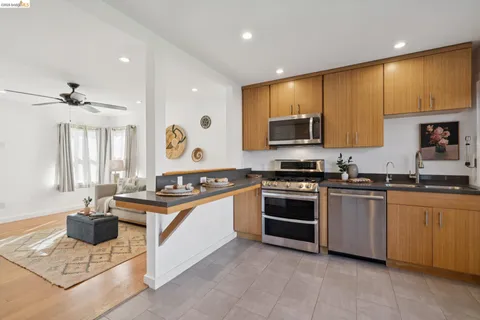 a kitchen with stainless steel appliances granite countertop a stove and a sink