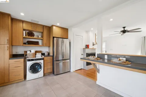 a kitchen with a refrigerator and a stove top oven