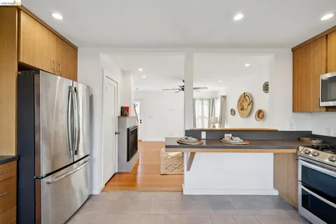 a kitchen with stainless steel appliances granite countertop a stove a refrigerator and a sink