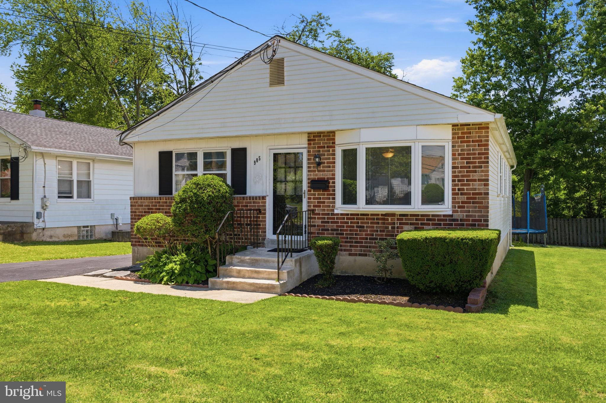905 Amosland Road Morton, PA 19070 - Photo 3 of 44 Charming brick home with lush greenery.