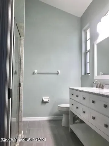 a bathroom with a glass shower door