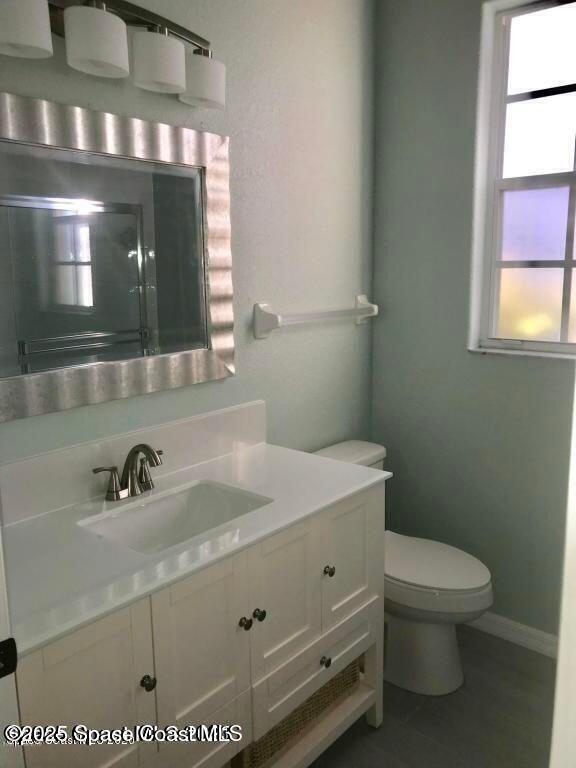 3121 Atocha Lane Indialantic, FL 32903 - Photo 14 of 17 a bathroom with a sink a toilet and mirror