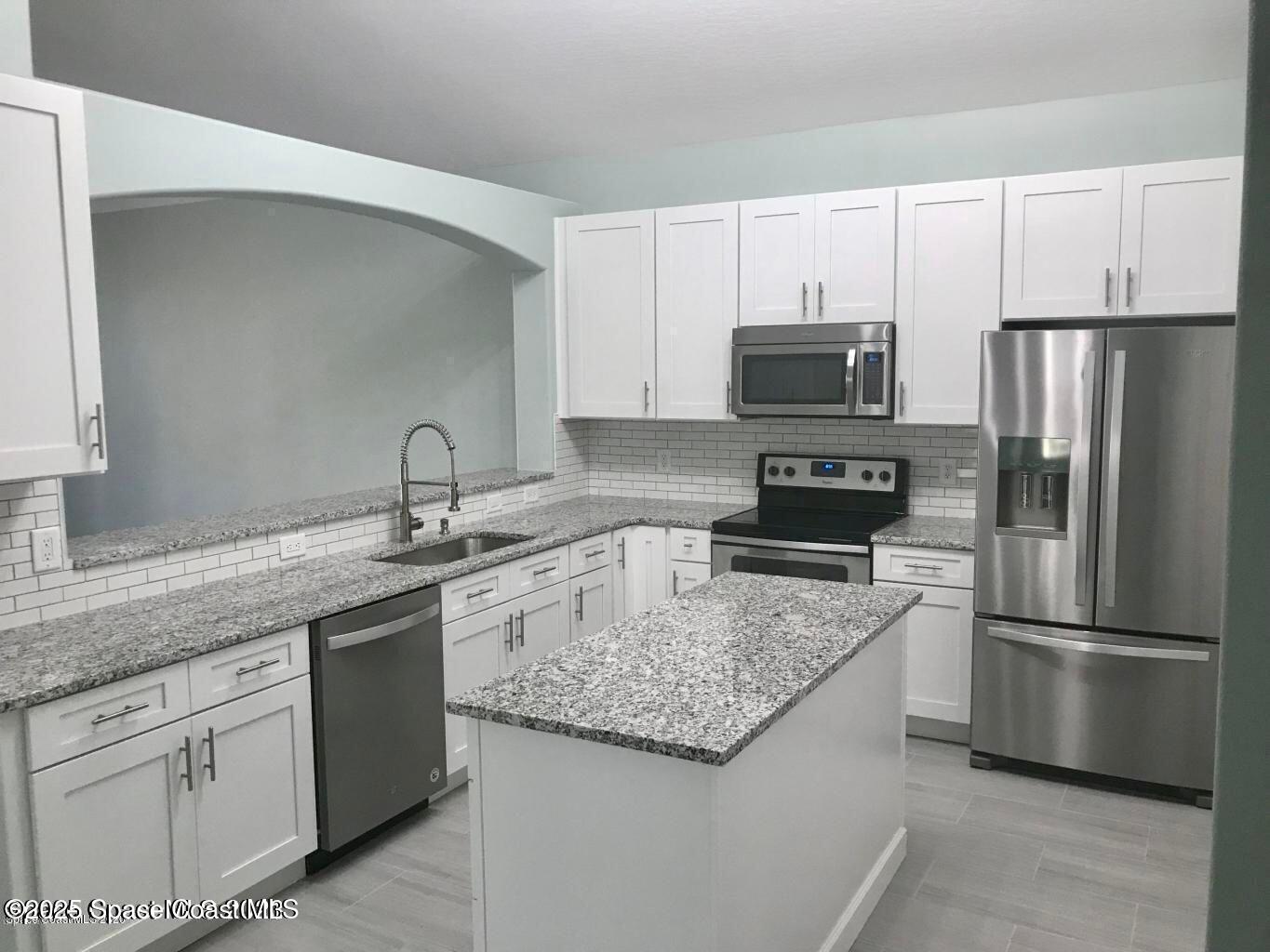 3121 Atocha Lane Indialantic, FL 32903 - Photo 2 of 17 a kitchen with appliances a sink and cabinets