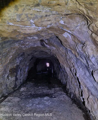 a view of house with yard and car parked