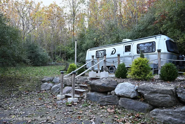 a view of a house with a yard and furniture