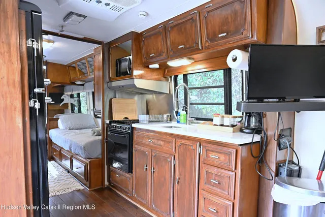 a kitchen with stainless steel appliances granite countertop a stove and a microwave