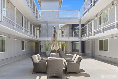 a view of a patio with a table and chairs