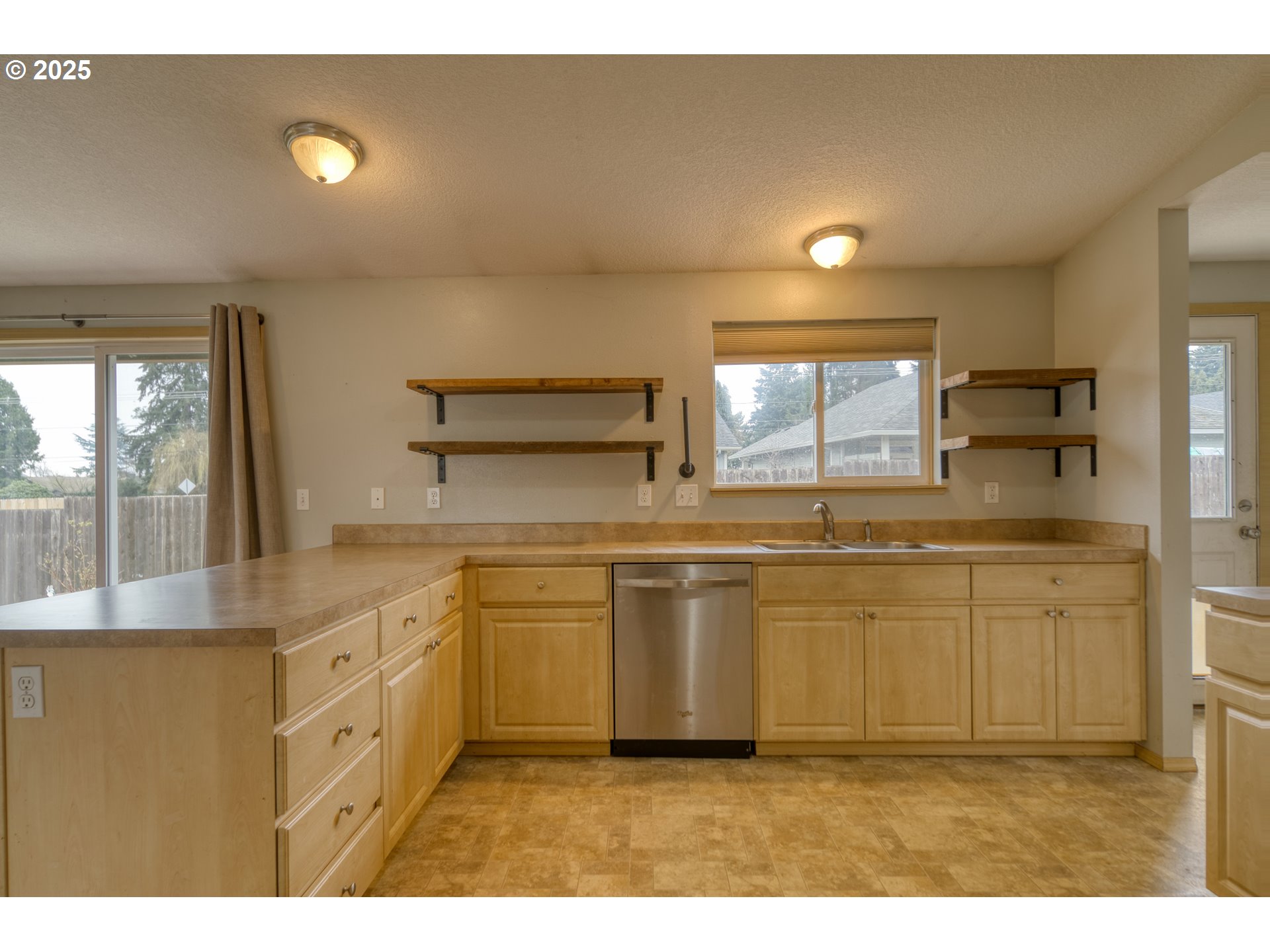 34122 Adison Street Scappoose, OR 97056 - Photo 11 of 41 a kitchen with kitchen island white cabinets appliances and a counter top space