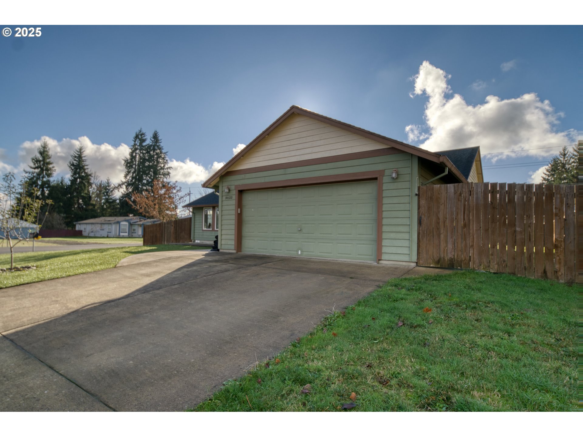 34122 Adison Street Scappoose, OR 97056 - Photo 29 of 41 a view of a house with a yard and garage