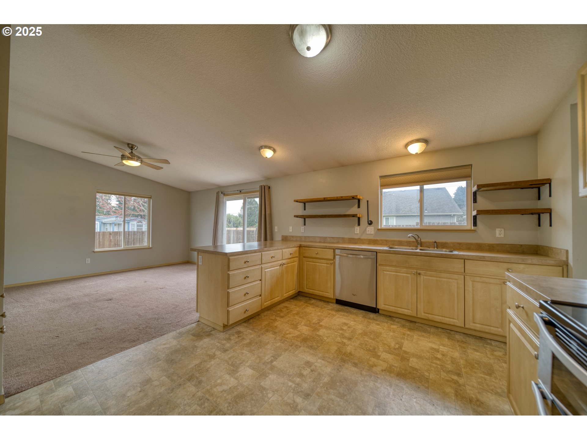 34122 Adison Street Scappoose, OR 97056 - Photo 9 of 41 a kitchen with stainless steel appliances a refrigerator sink and stove