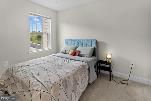 a bedroom with a bed and window