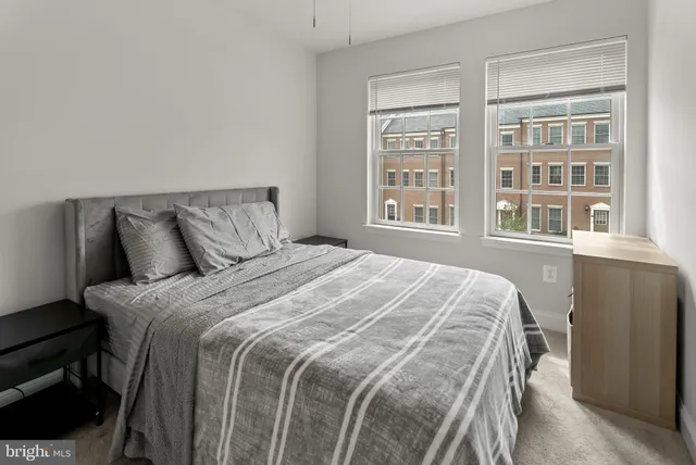 a large bed sitting in a bedroom next to a window