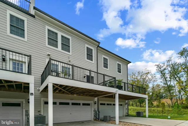 a view of a house with a yard and balcony