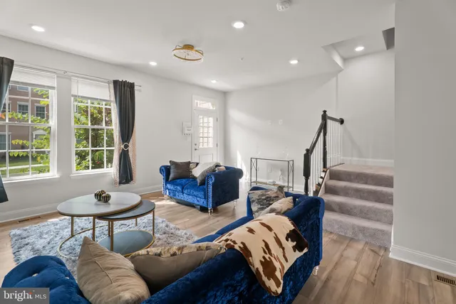 a living room with furniture and a potted plant