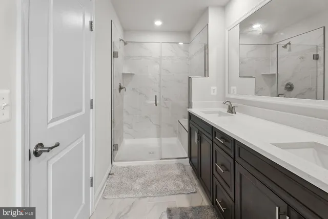 a spacious bathroom with a shower sink and mirror