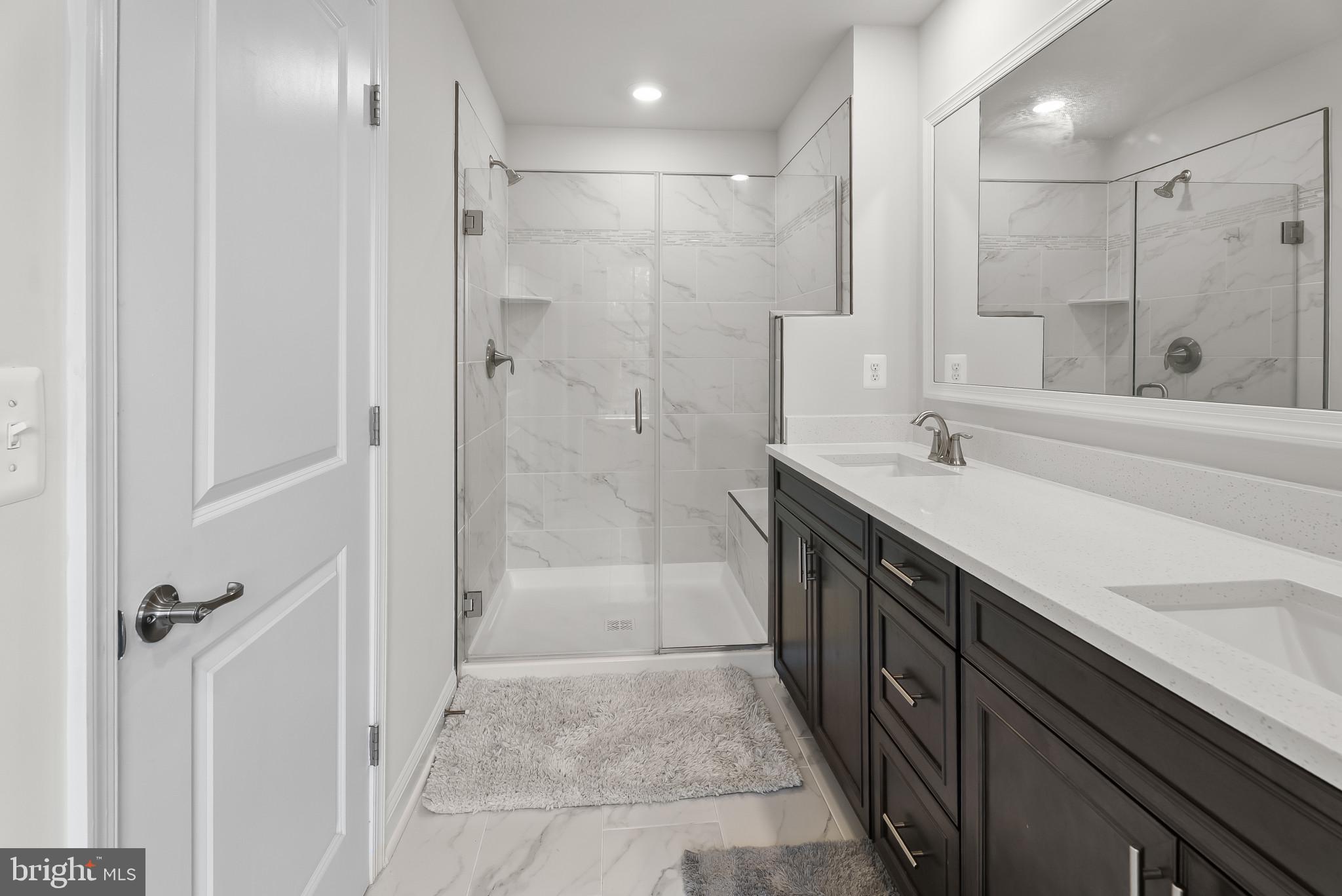 7202 Conley Alley Sykesville, MD 21784 - Photo 6 of 24 a spacious bathroom with a shower sink and mirror