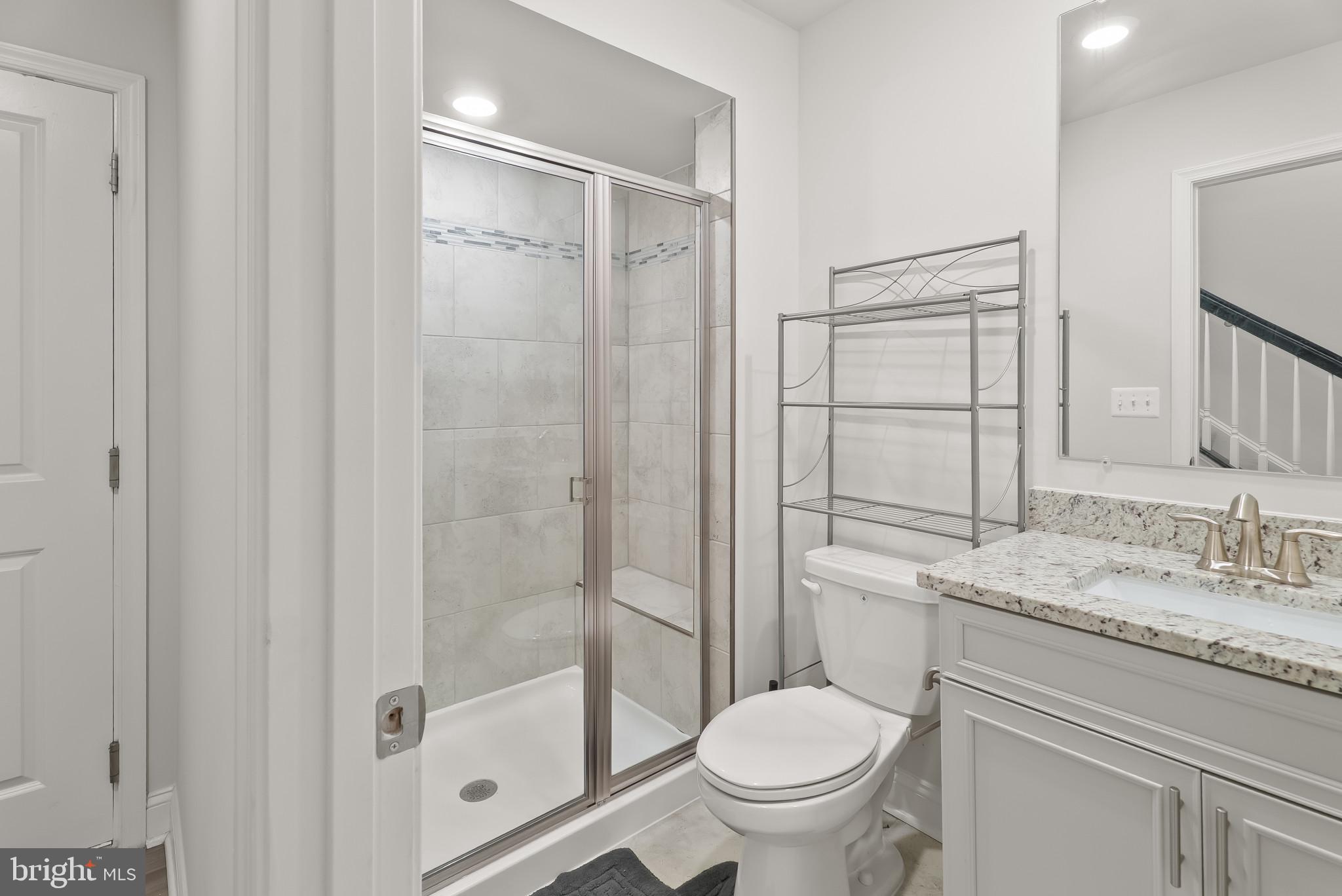 7202 Conley Alley Sykesville, MD 21784 - Photo 10 of 24 a bathroom with a granite countertop sink toilet and shower