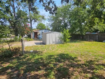 a swimming pool with outdoor seating and yard