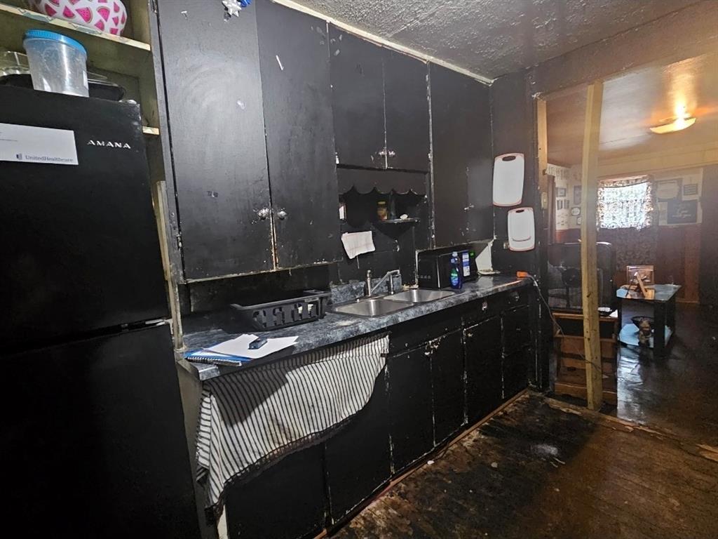3500 Baylor Street Fort Worth, TX 76119 - Photo 6 of 16 a bathroom with a granite countertop sink a vanity and a mirror