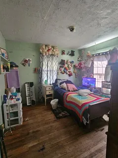 a bedroom with bed and a window