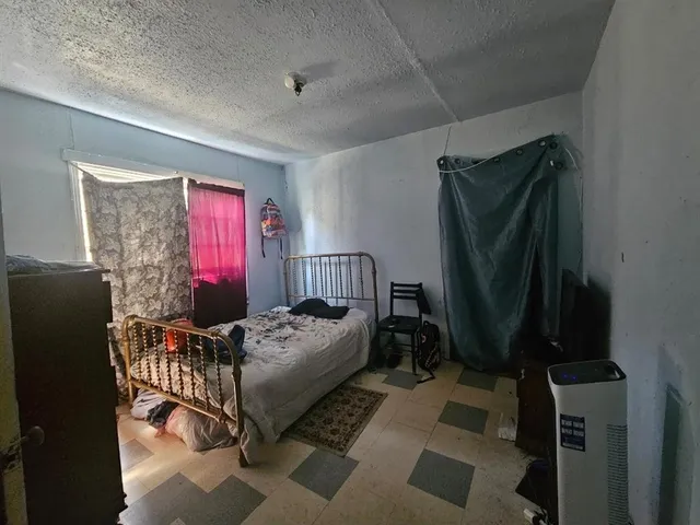 a bedroom with furniture and a window