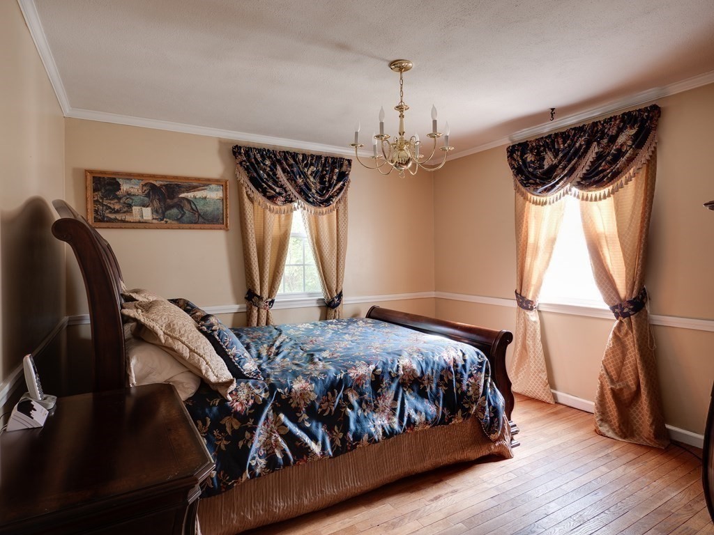 357 Massachusetts Avenue West Springfield, MA 01089 - Photo 11 of 22 a bedroom with a bed window and a wooden floor