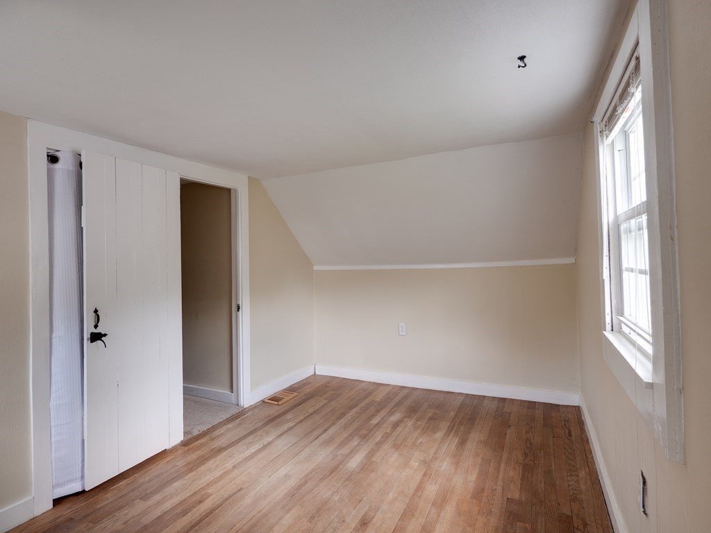 357 Massachusetts Avenue West Springfield, MA 01089 - Photo 13 of 22 an empty room with wooden floor and windows