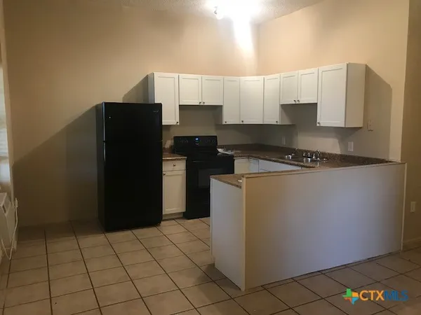 a kitchen with a sink a stove and refrigerator