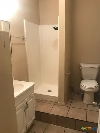 a bathroom with a toilet a sink and a shower