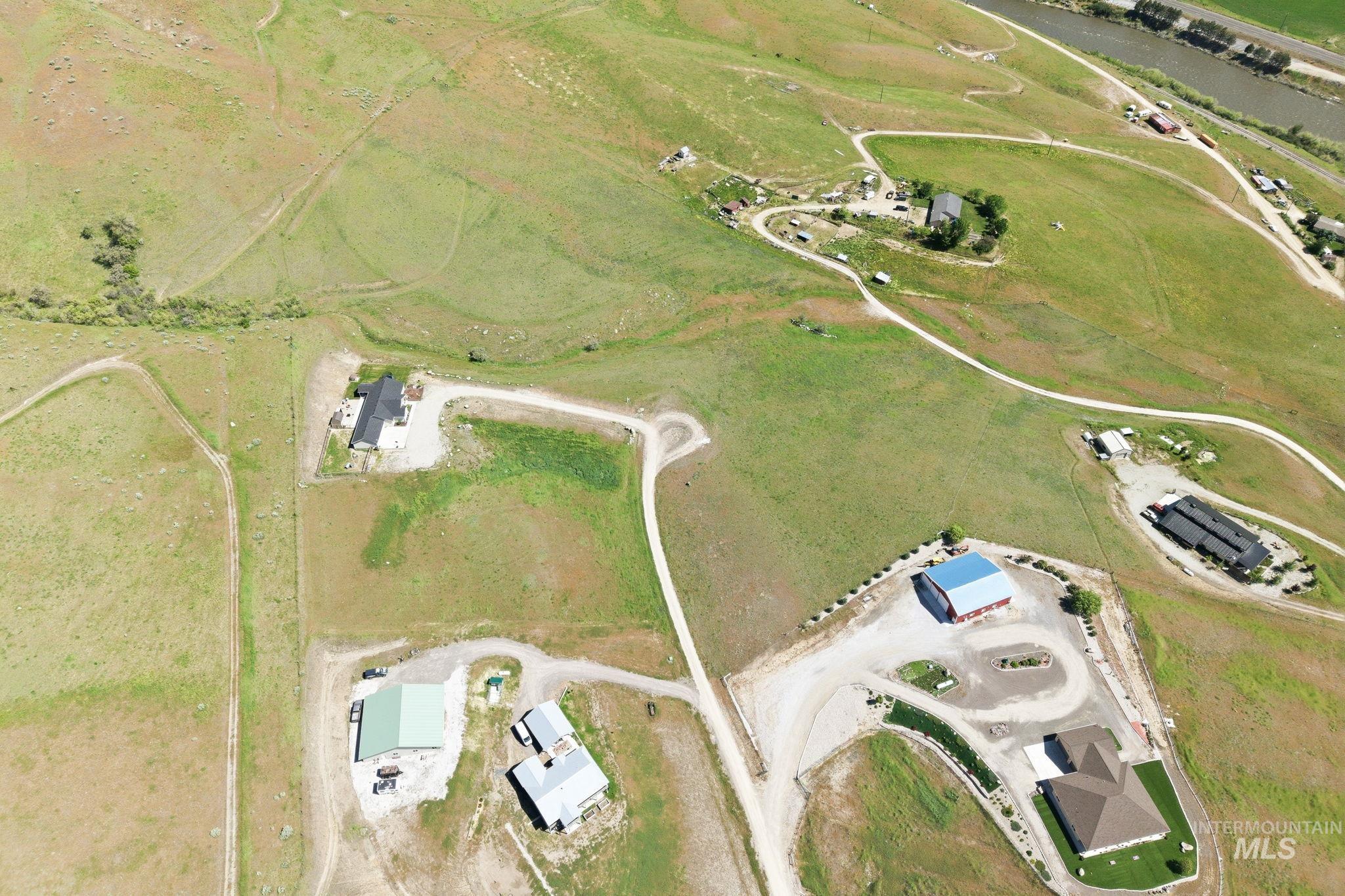 25 River Ridge Horseshoe Bend, ID 83629 - Photo 11 of 50 Expansive acreage featuring multiple structures, open fields, and gravel driveways