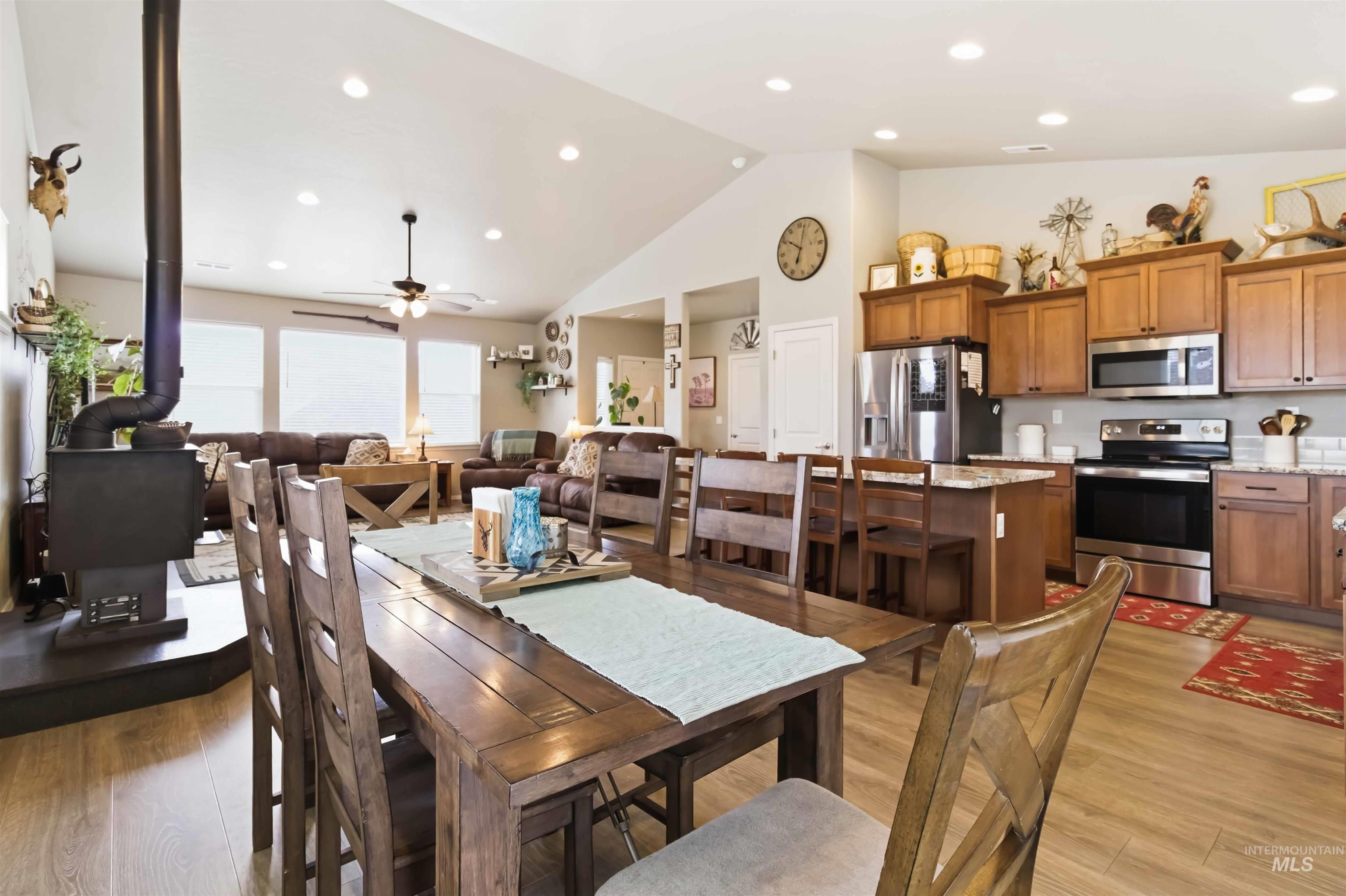 25 River Ridge Horseshoe Bend, ID 83629 - Photo 16 of 50 Dining room featuring light wood-type flooring, vaulted ceiling, a wood stove, recessed lighting, and ceiling fan