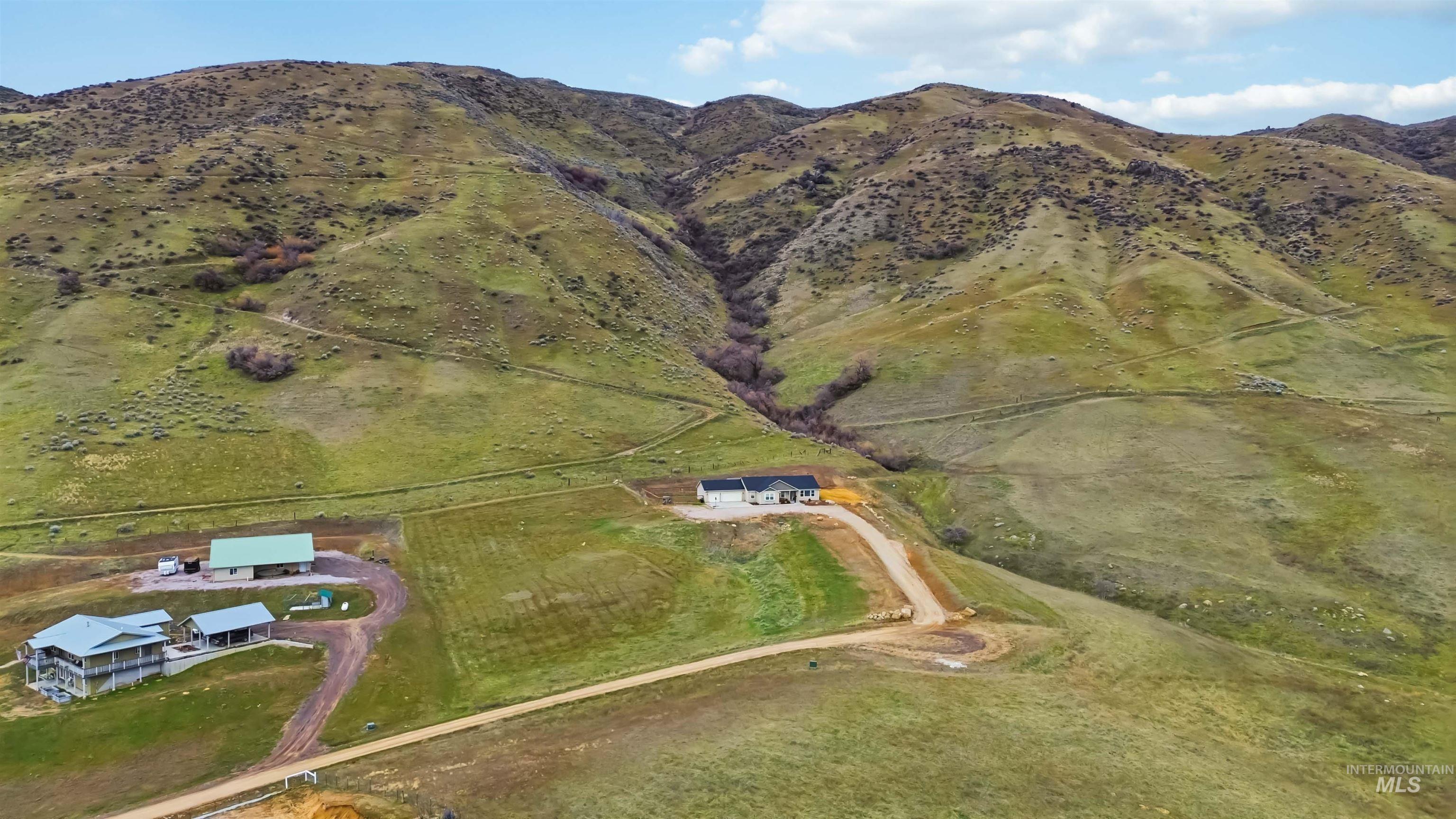 25 River Ridge Horseshoe Bend, ID 83629 - Photo 2 of 50 Aerial view of sparsely populated area with a mountain backdrop