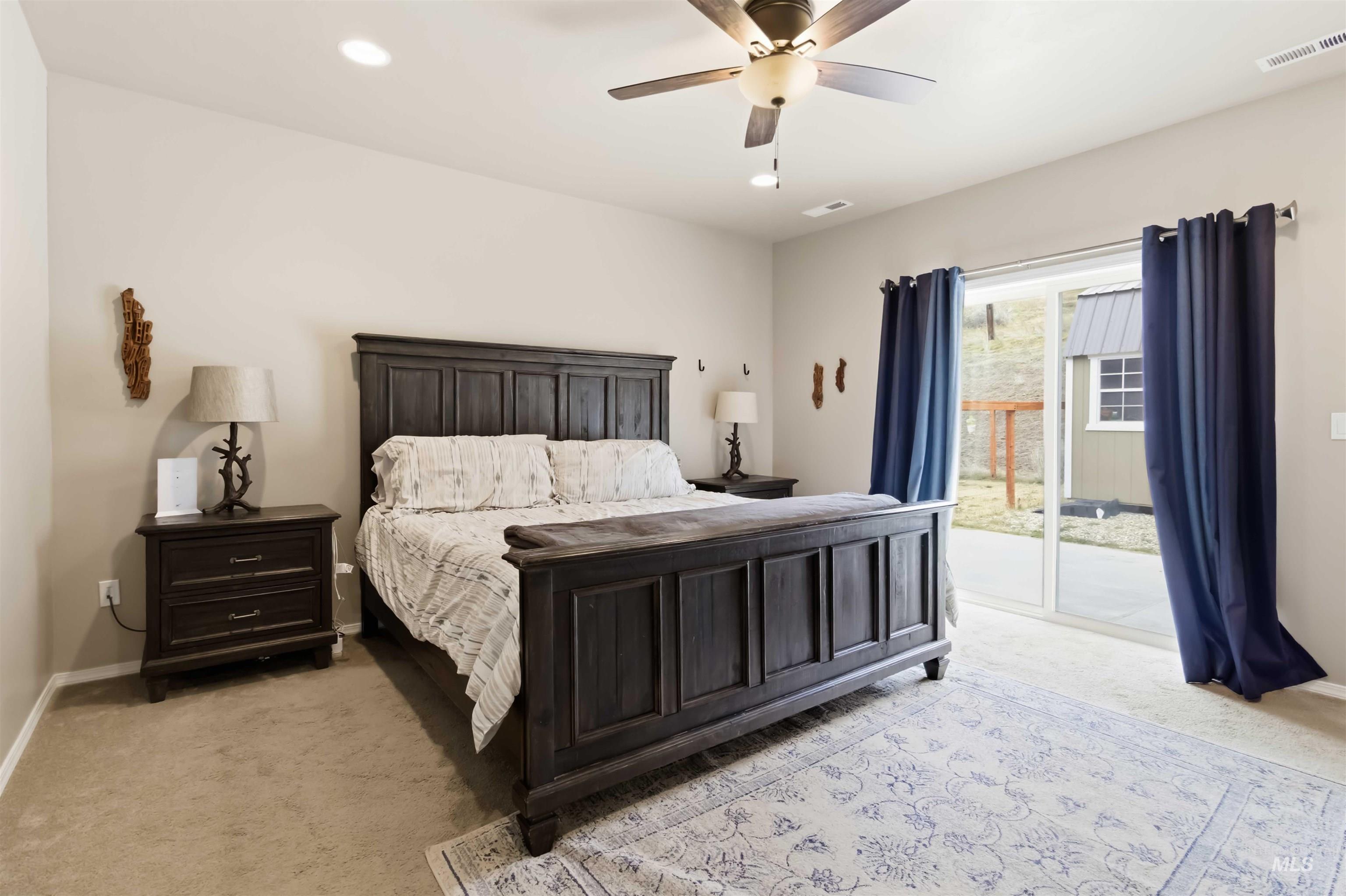 25 River Ridge Horseshoe Bend, ID 83629 - Photo 20 of 50 Bedroom with light colored carpet, access to exterior, a ceiling fan, and recessed lighting