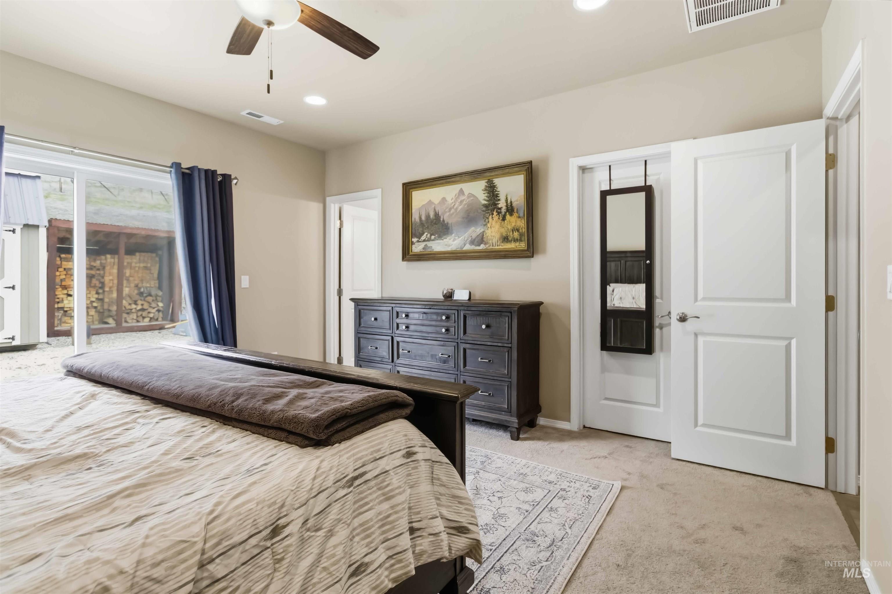 25 River Ridge Horseshoe Bend, ID 83629 - Photo 21 of 50 Bedroom featuring light colored carpet, access to exterior, ceiling fan, and recessed lighting