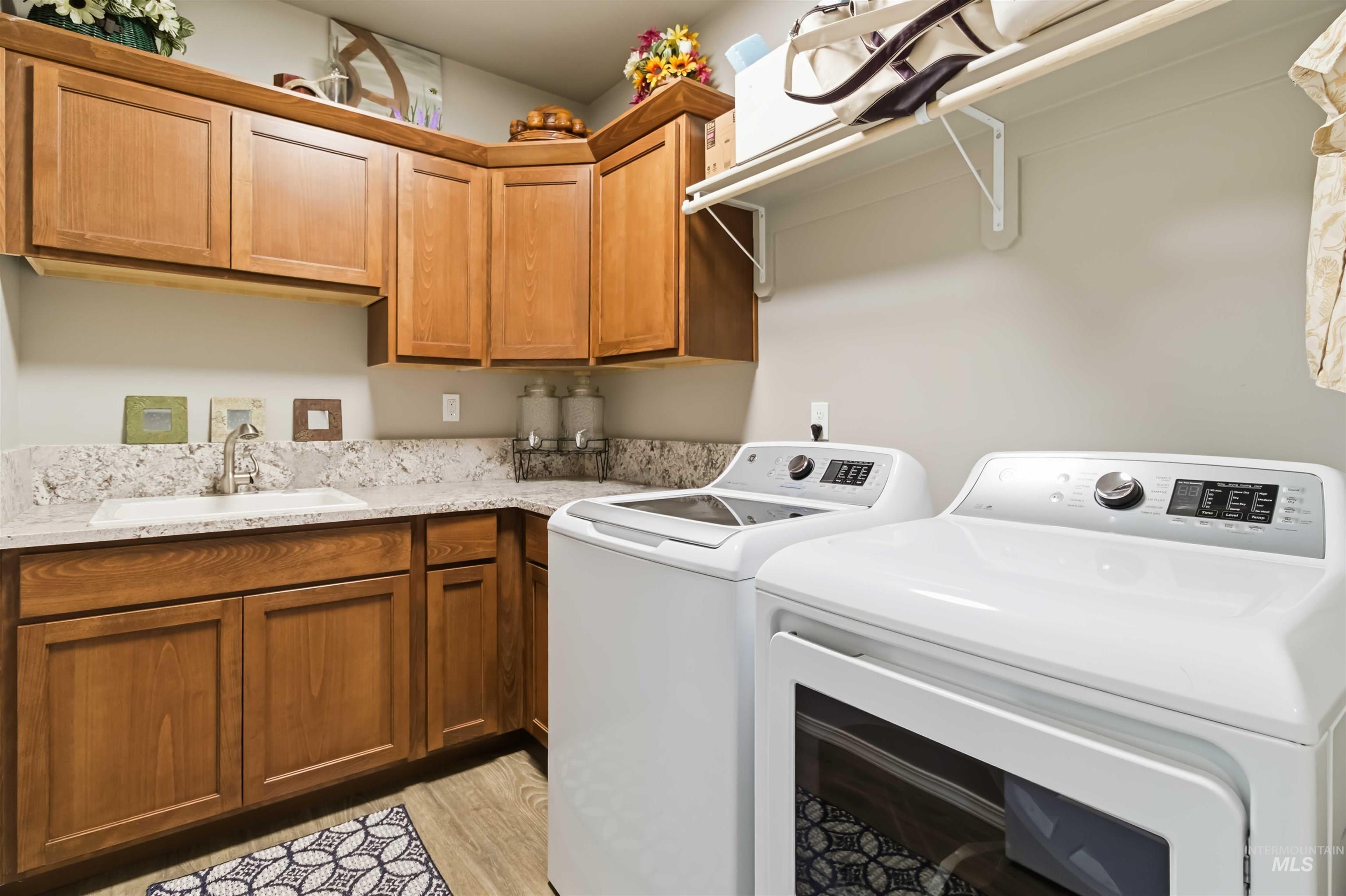 25 River Ridge Horseshoe Bend, ID 83629 - Photo 32 of 50 Laundry area featuring washer and dryer, cabinet space, and light wood-style floors