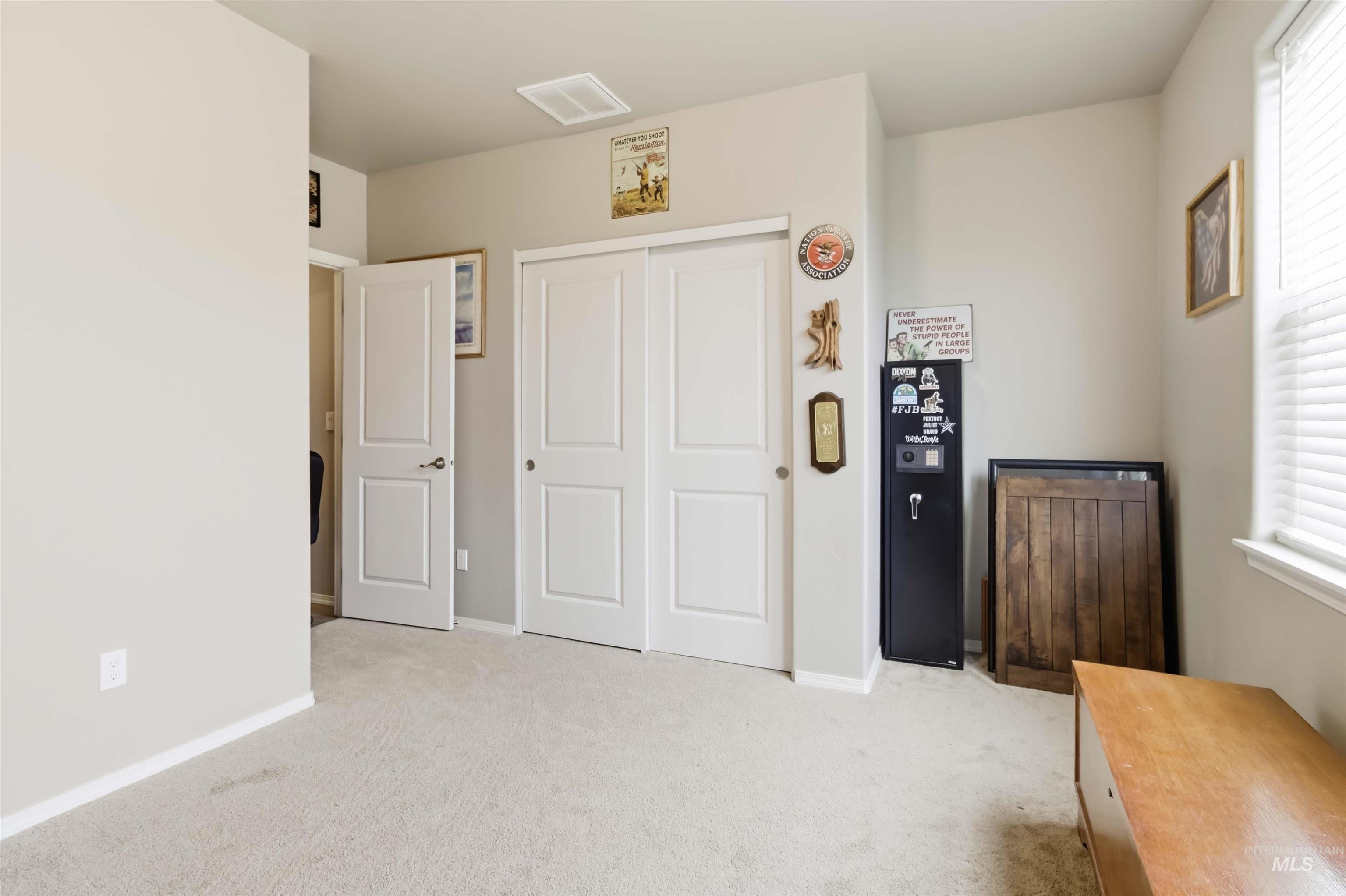 25 River Ridge Horseshoe Bend, ID 83629 - Photo 36 of 50 Bedroom featuring light carpet, a closet, and multiple windows