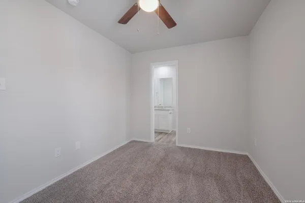 an empty room with a empty space and a ceiling fan