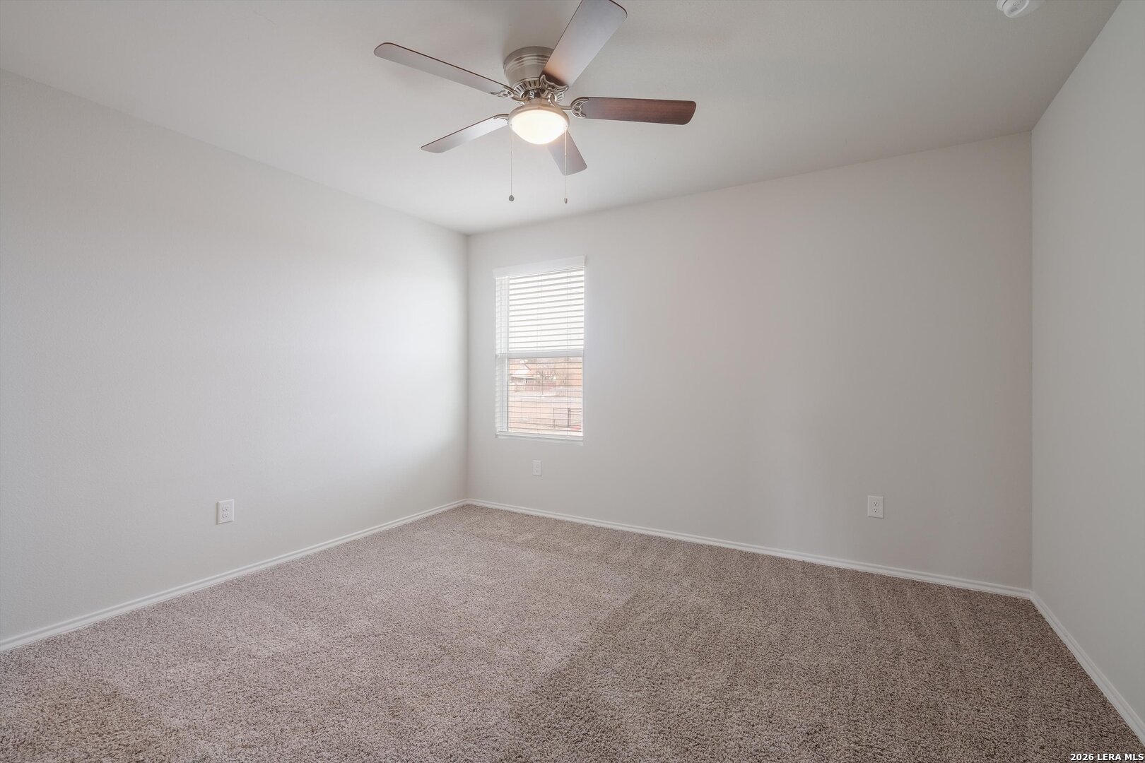 7356 Misty Ridge Drive, Unit 101 Converse, TX 78109 - Photo 13 of 18 an empty room with a window and a ceiling fan