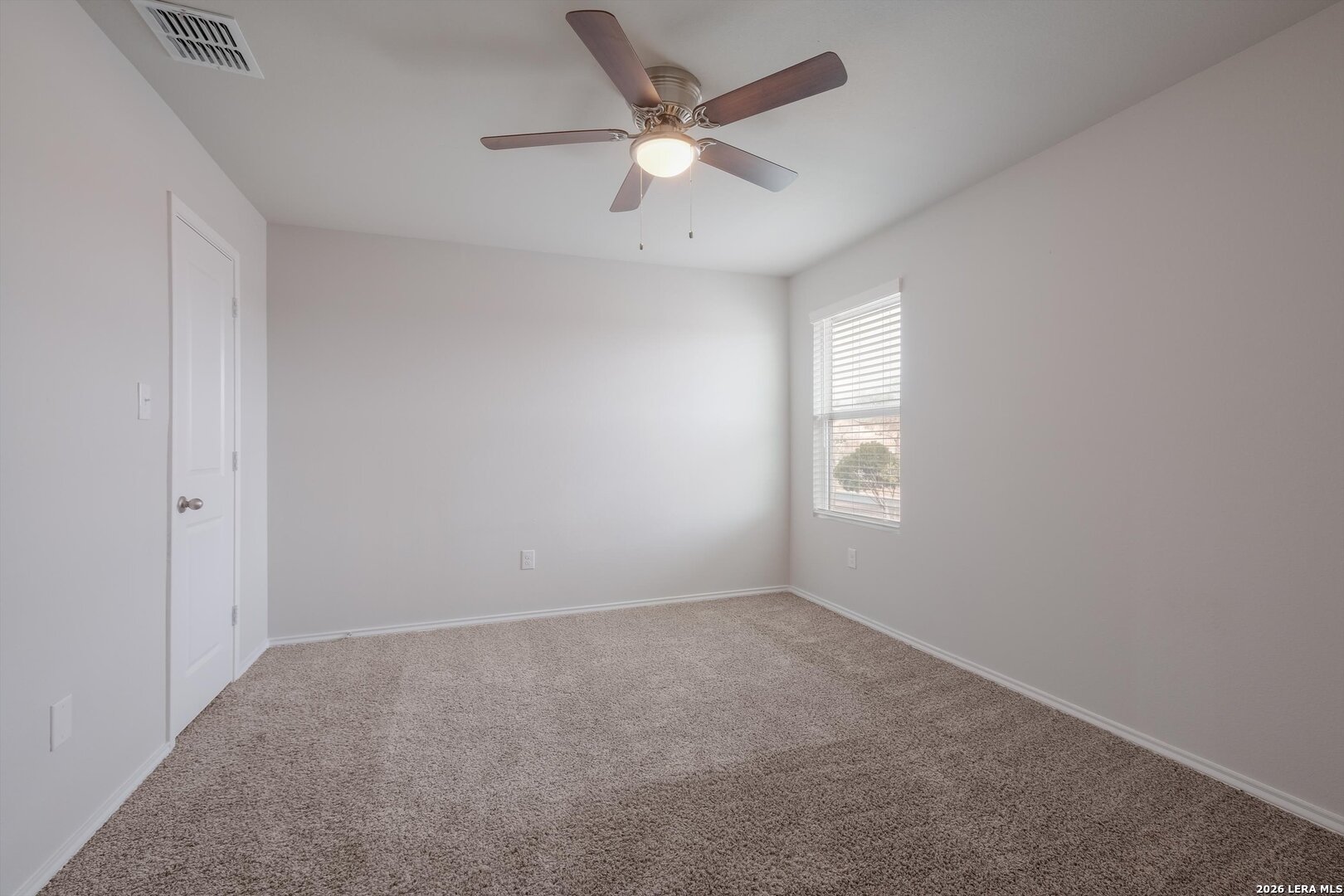 7356 Misty Ridge Drive, Unit 101 Converse, TX 78109 - Photo 14 of 18 an empty room with a window and a fan