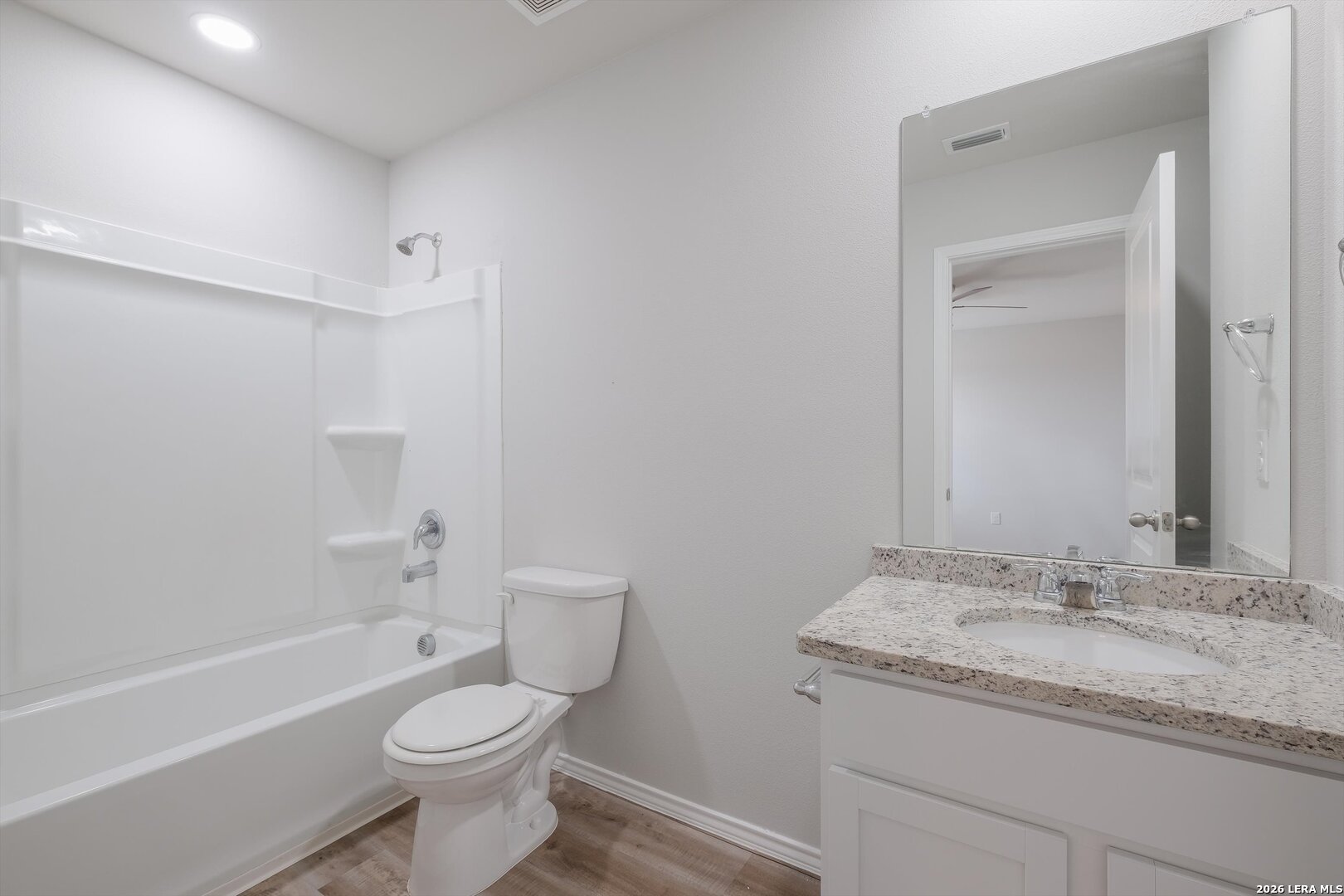 7356 Misty Ridge Drive, Unit 101 Converse, TX 78109 - Photo 15 of 18 a bathroom with a granite countertop sink toilet and shower