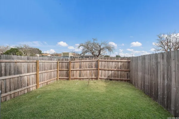 a view of a backyard with a fence