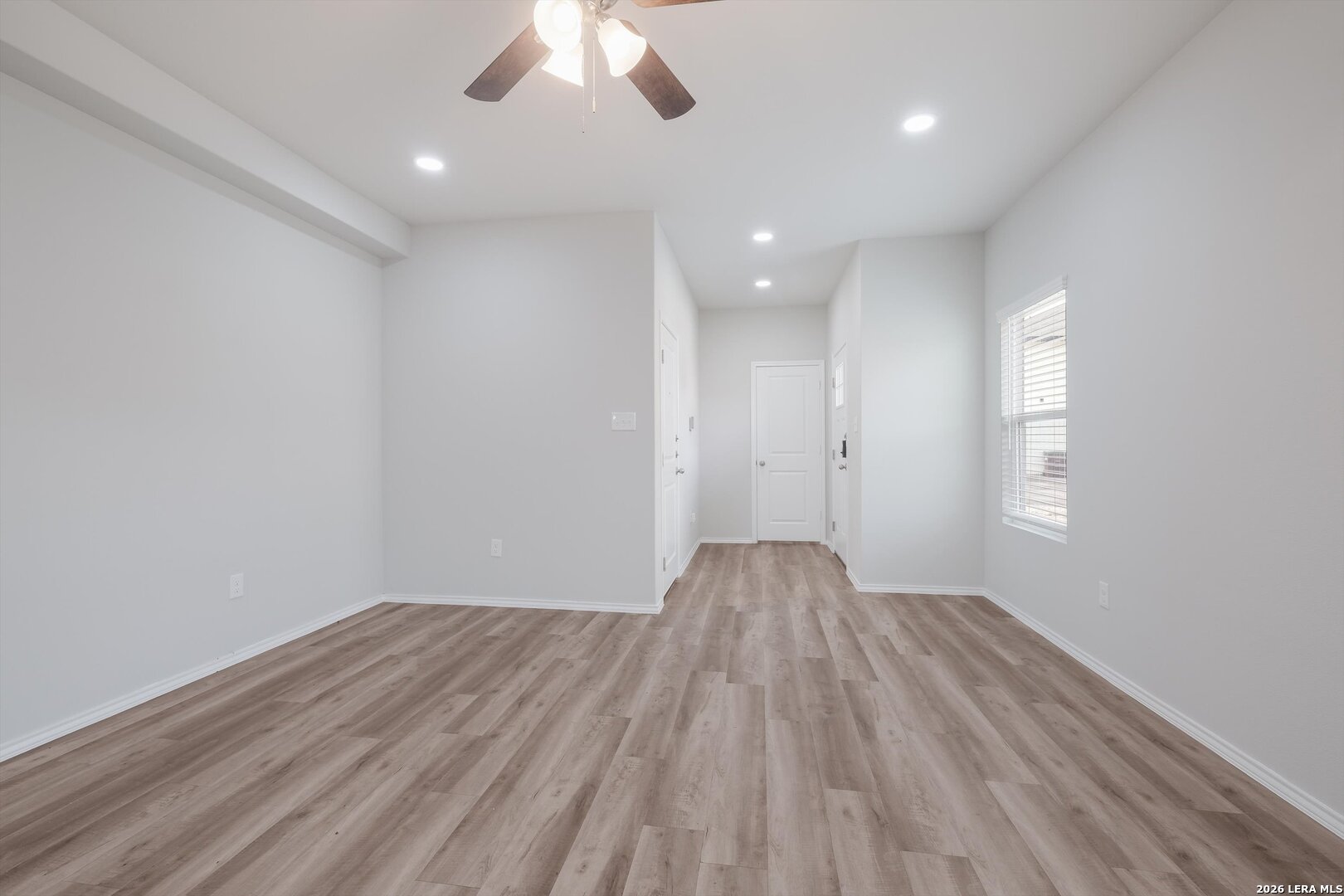 7356 Misty Ridge Drive, Unit 101 Converse, TX 78109 - Photo 4 of 18 wooden floor in an empty room with a window