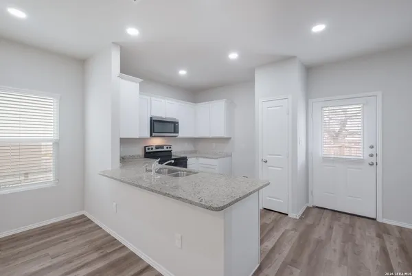 a kitchen with a sink microwave and cabinets