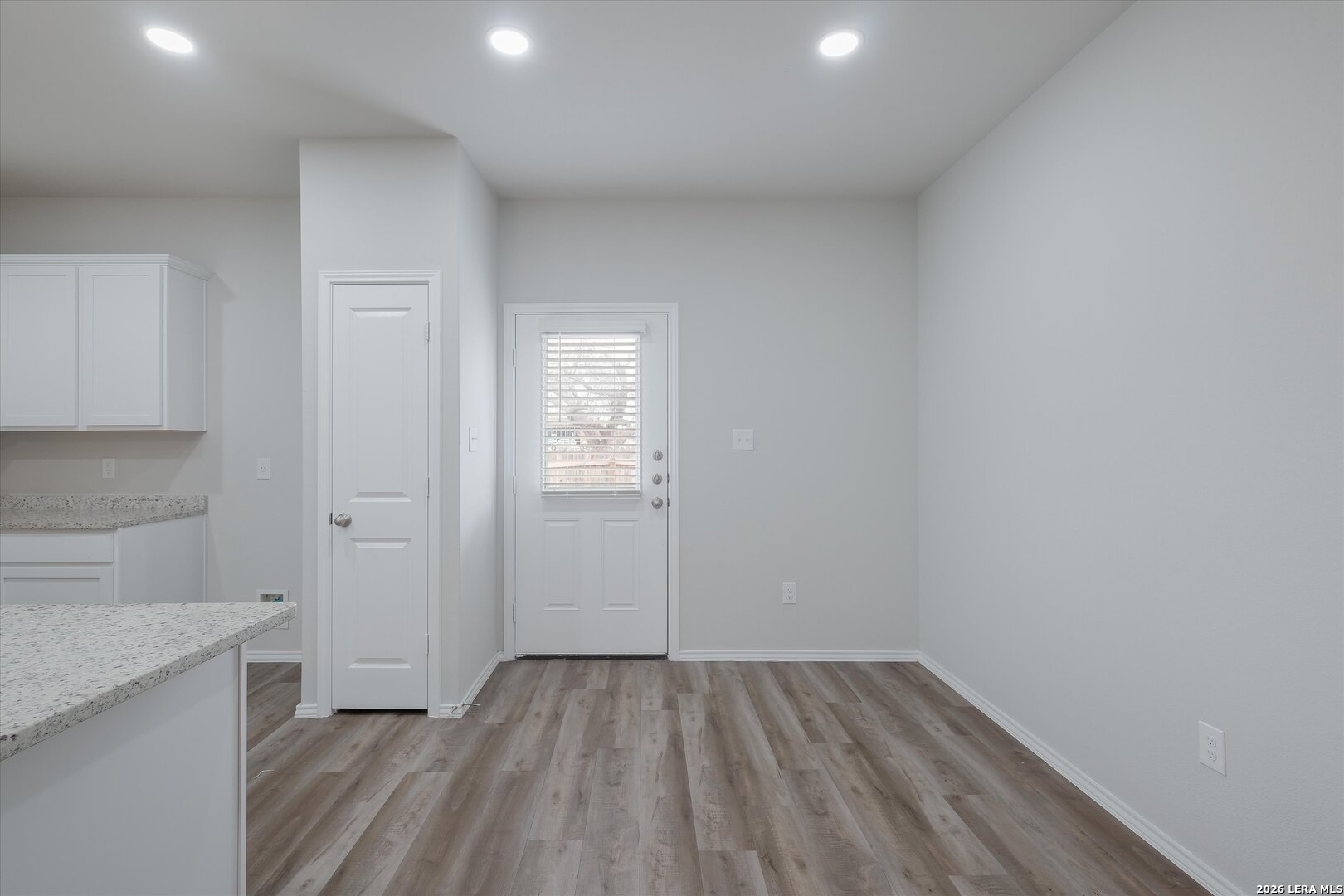 7356 Misty Ridge Drive, Unit 101 Converse, TX 78109 - Photo 8 of 18 a view of empty room with wooden floor and cabinet